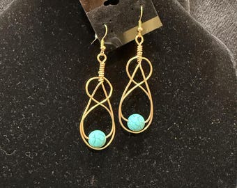 Turquoise like bead interwoven by gold wire loops earrings