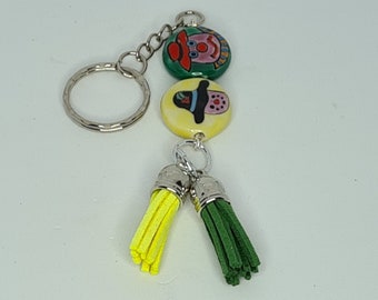 Keyring- Key Chain- Bag Charm- Handmade Hand Painted Ceramic Beads- Faux Suede Tassels- Handmade- Scarecrow Faces- Green And Yellow