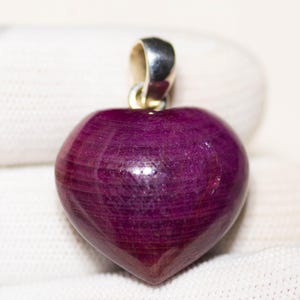 May include: A white ceramic mug with a black handle and the text "But First, Coffee" in a black, bold font. The mug is on a white surface. The mug is approximately 10 cm tall.