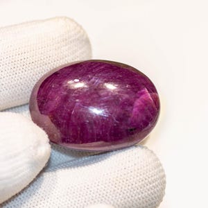 May include: A set of three ceramic mugs with a speckled, matte finish. The mugs are in shades of cream, light gray, and dark gray. Each mug has a simple, minimalist design and a rounded handle.