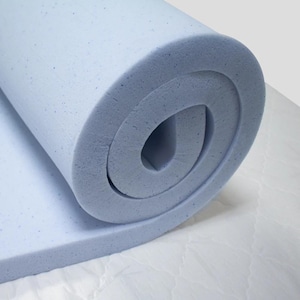 May include: A rolled up light blue memory foam mattress topper. The topper is made of a soft, comfortable material and is designed to provide extra support and comfort for your bed.