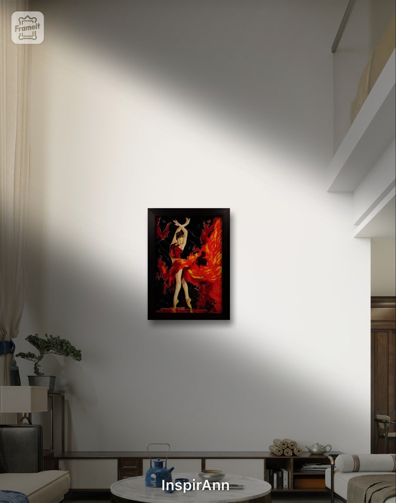 May include: A framed painting of a woman in a red dress with a fiery background. The painting is in a black frame and is hanging on a white wall.