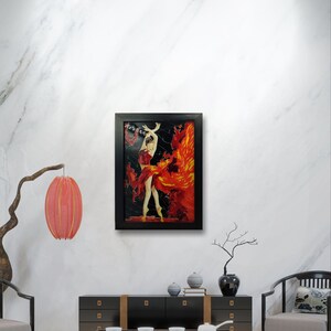 May include: A framed painting of a woman in a red dress dancing with flames behind her. The painting is set against a white marble wall with a black frame.