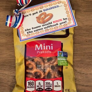 May include: A bag of mini pretzels with a red, white and blue ribbon and a card that says "Don't get it twisted... the team would knot be the same without you!"