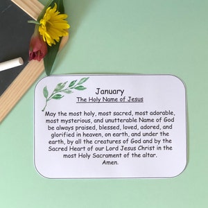 May include: A white card with green watercolour leaves and the text "January" and "The Holy Name of Jesus". The card has a prayer for the Holy Name of Jesus.