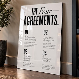 May include: A rectangular white wall art print featuring the black text The Four Agreements. It lists four numbered principles: Be Impeccable With Your Word, Don't Make Assumptions, Don't Take Anything Personally, and Always Do Your Best.