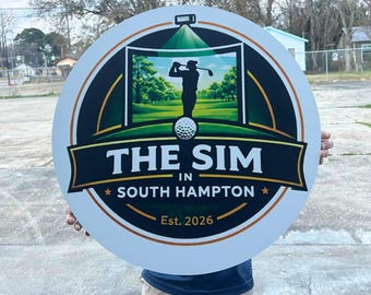 May include: A circular sign featuring a black and green graphic of a golfer in a simulator, with the text "THE SIM IN SOUTH HAMPTON" and "Est. 2026" printed in white and gold. The design includes a golf ball icon and a projector light graphic.