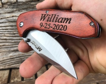 May include: A wooden handled pocket knife with a silver blade. The handle is engraved with the name "William" and the date "9-25-2020".