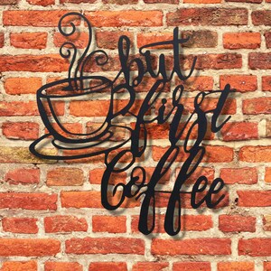 May include: Black metal wall art with a coffee cup and the text "But first, coffee".
