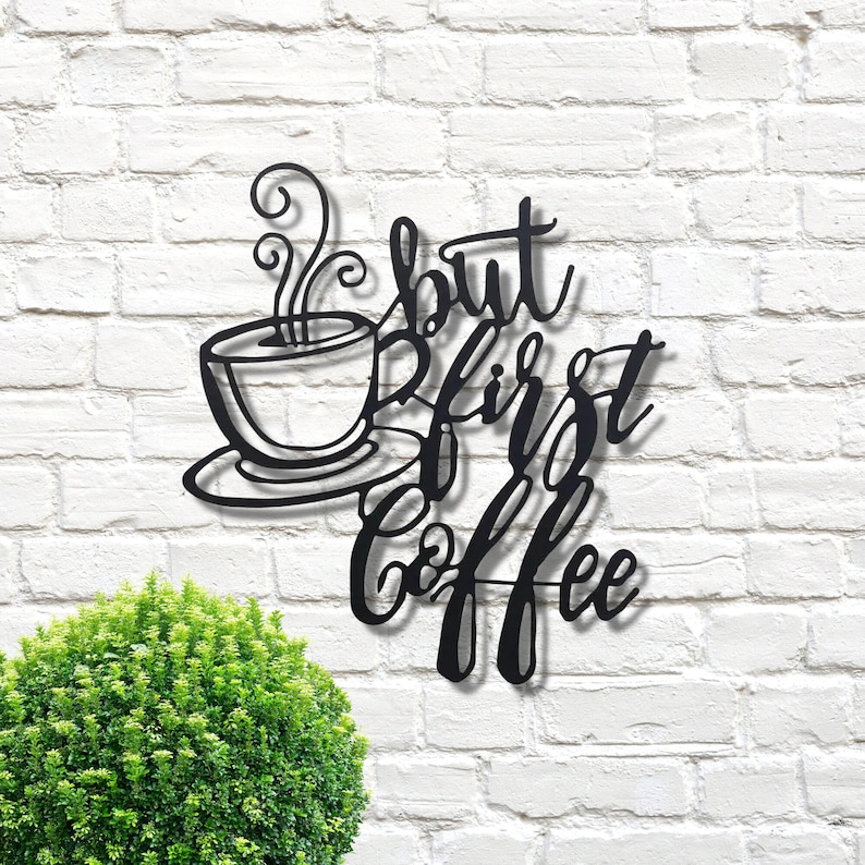 May include: Black metal wall decor with a coffee cup and the text "But first, coffee".