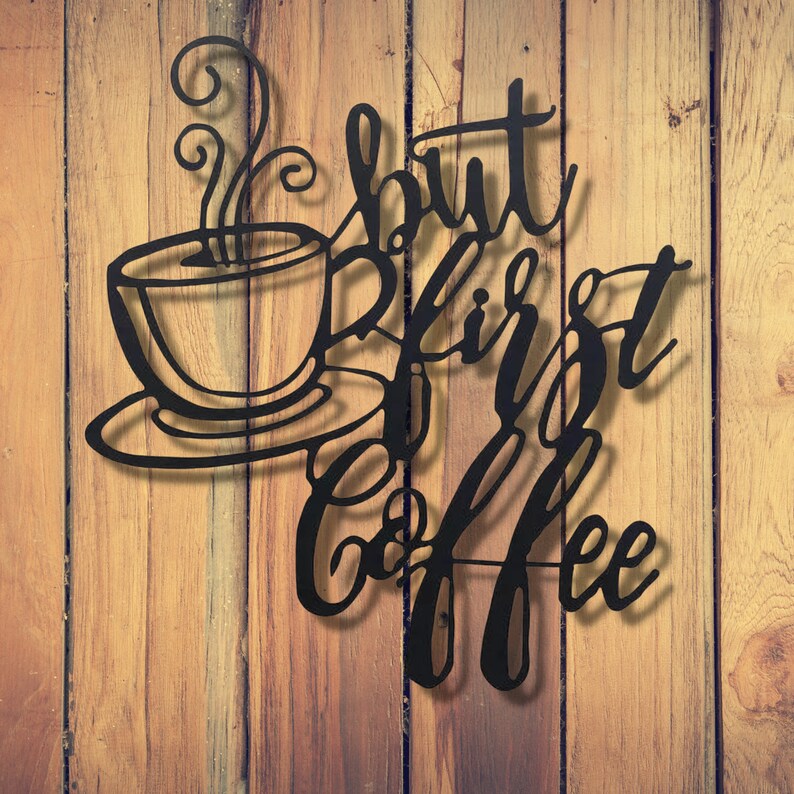 May include: Black metal wall decor with the text "But first, coffee" and a stylized image of a coffee cup with steam rising from it.