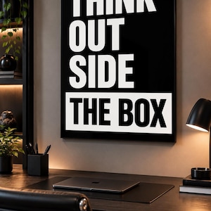 May include: A rectangular wall art print featuring a black background with the white text THINK OUT SIDE in a bold sans-serif font, followed by the text THE BOX in black letters on a white rectangular background block.