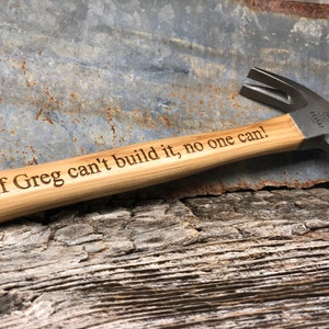May include: A wooden-handled hammer with a metal head. The handle is engraved with the text "If Greg can't build it, no one can!"