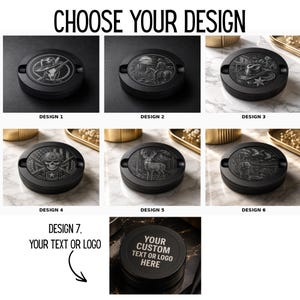 May include: A collection of seven round black ashtrays featuring various engraved designs including a skull with a hat, a cowboy on a horse, a western landscape, a military skull, a deer, a duck scene, and a custom text or logo option.