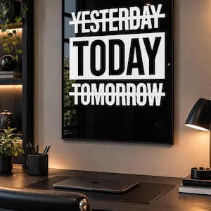 May include: A rectangular wall art piece featuring a black background with white text that reads YESTERDAY with a line through it, TODAY in a large white box, and TOMORROW with a line through it. The print is framed in a thin black frame.