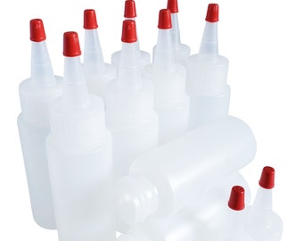 May include: A group of clear plastic bottles with red squeeze tops. The bottles are various sizes and are stacked on top of each other.