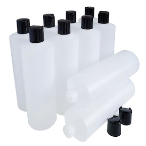 May include: Ten clear plastic bottles with black screw-on caps. The bottles are cylindrical and have a smooth, opaque finish. The bottles are arranged in a group, with some bottles stacked on top of others.