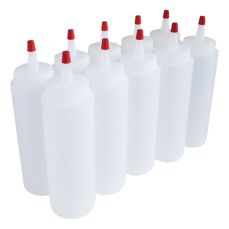 May include: Ten clear plastic squeeze bottles with red caps. The bottles are all the same size and shape, and they are arranged in a row.