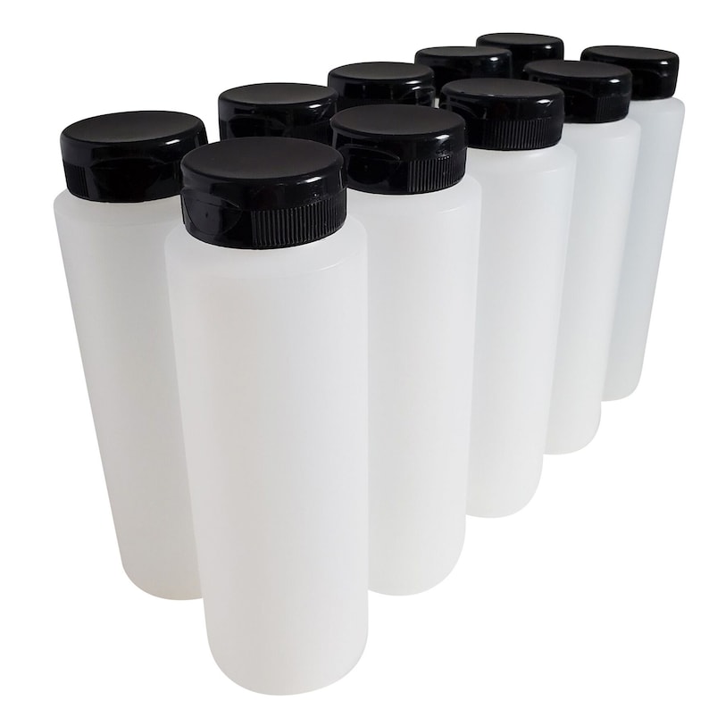 May include: Ten clear plastic bottles with black screw-on lids. The bottles are lined up in a row, with the lids facing the viewer.