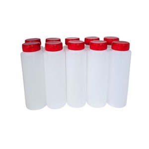 May include: Ten clear plastic bottles with red screw-on lids. The bottles are all the same size and shape.