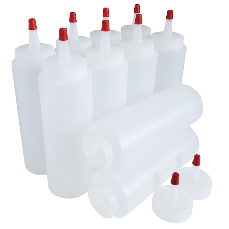 May include: A set of ten clear plastic squeeze bottles with red caps. The bottles are stacked and arranged in a group.