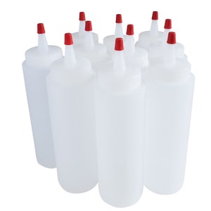 May include: Eight clear plastic squeeze bottles with red caps. The bottles are all the same size and shape, and they are arranged in a row.