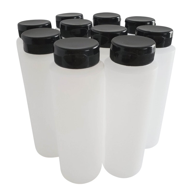 May include: Ten clear plastic bottles with black screw-on lids. The bottles are arranged in a semi-circle.