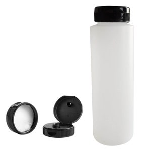 May include: A white plastic bottle with a black screw-on cap. The cap has a small hole in the top. The bottle is empty and ready to be filled.