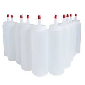 May include: Ten clear plastic squeeze bottles with red caps. The bottles are arranged in a semi-circle shape.