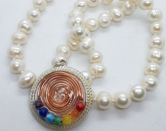 Natural pearl necklace with copper spiral pendant, white quartz and seven chakras.