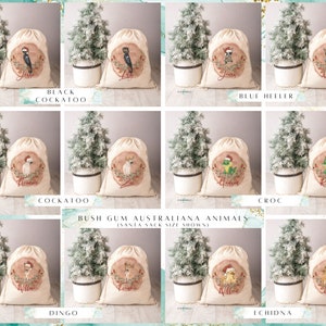 May include: Set of ten Christmas gift bags featuring Australian animals. Each bag is made of natural canvas fabric and features a different animal illustration, including a black cockatoo, blue heeler, cockatoo, crocodile, dingo, and echidna. The bags are decorated with a red and white Christmas theme.