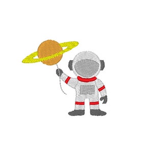 May include: Embroidered design of an astronaut holding a planet with rings. The astronaut is wearing a white spacesuit with red accents and a gray helmet. The planet is orange with yellow rings.