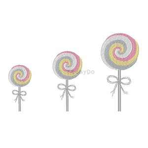 May include: Three embroidered lollipops in varying sizes. Each lollipop features a spiral design in pink, yellow, and gray, with a gray stick and a bow. The design is on a white background.