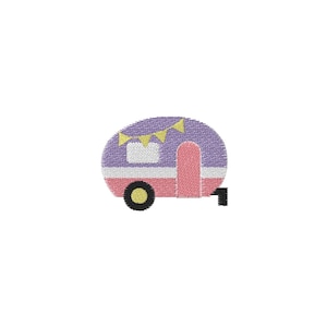 May include: An embroidered camper in shades of purple, pink, and white, with a yellow banner. The camper has a black wheel and a black hitch. The design is on a white background.