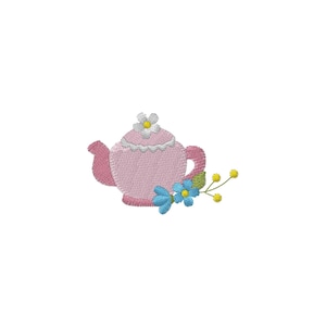 May include: Embroidered pink teapot with a white lace trim on the lid and handle. Adorned with blue and yellow floral accents. The teapot is set against a white background, creating a delicate and charming design.