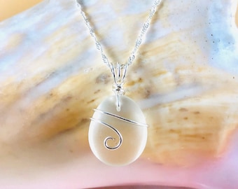 Unique triangular pendant with a pale sea glass wrapped in silver coated copper wire and a smokey glass bead dangling under.
