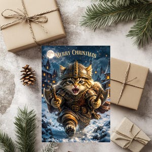 May include: A rectangular greeting card featuring a tabby cat dressed in ornate metal armor and a helmet, holding two small axes. The cat is running through a snowy village at night under a full moon. The text Merry Christmas is printed in gold.