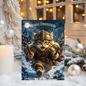 May include: A rectangular Christmas greeting card featuring a tabby cat dressed in detailed bronze-colored medieval armor and a helmet, holding two small axes. The cat is running through a snowy landscape with a village in the background and the text Merry Christmas.