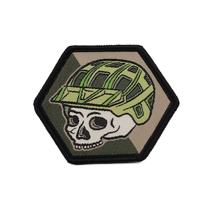 May include: A green and brown camouflage skull wearing a green helmet with a black outline. The skull is in a hexagonal shape.