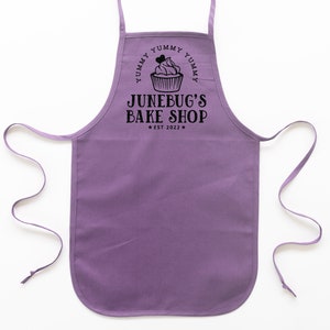 a toddler personalized cupcake baking apron in purple