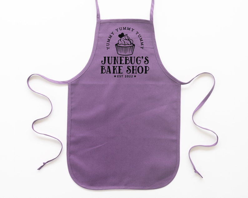 a toddler personalized cupcake baking apron in purple
