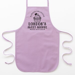 a toddler personalized cupcake baking apron in purple pastel