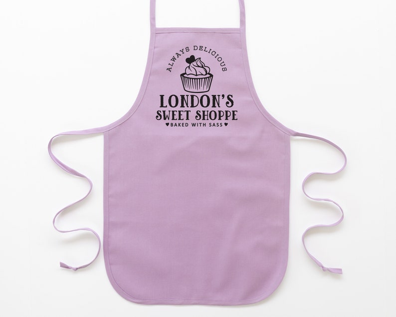 a toddler personalized cupcake baking apron in purple pastel