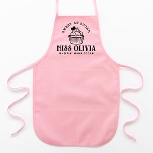 a toddler personalized cupcake baking apron in pink pastel