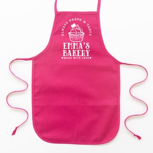 a toddler personalized cupcake baking apron in hot pink