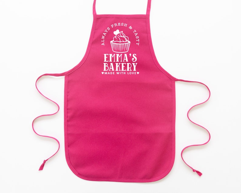 a toddler personalized cupcake baking apron in hot pink