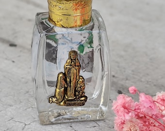 French Catholic bottle of holy water with a statuette of Lourdes on top