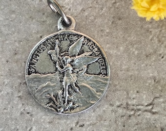 Antique religious medal of Saint Michael in silver color