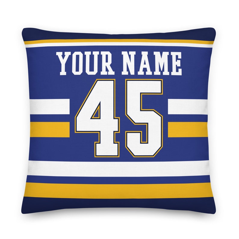 May include: Blue and gold throw pillow with white stripes and the text "YOUR NAME" and the number "45" in white.