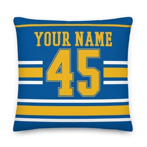 May include: Blue and gold personalized pillow with the text "YOUR NAME" and the number "45" in a jersey style.
